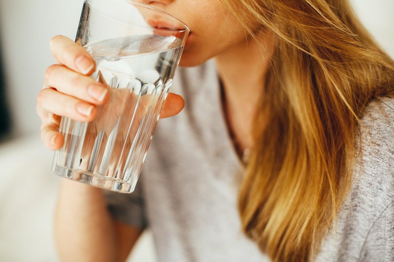 woman drinking a glass of water