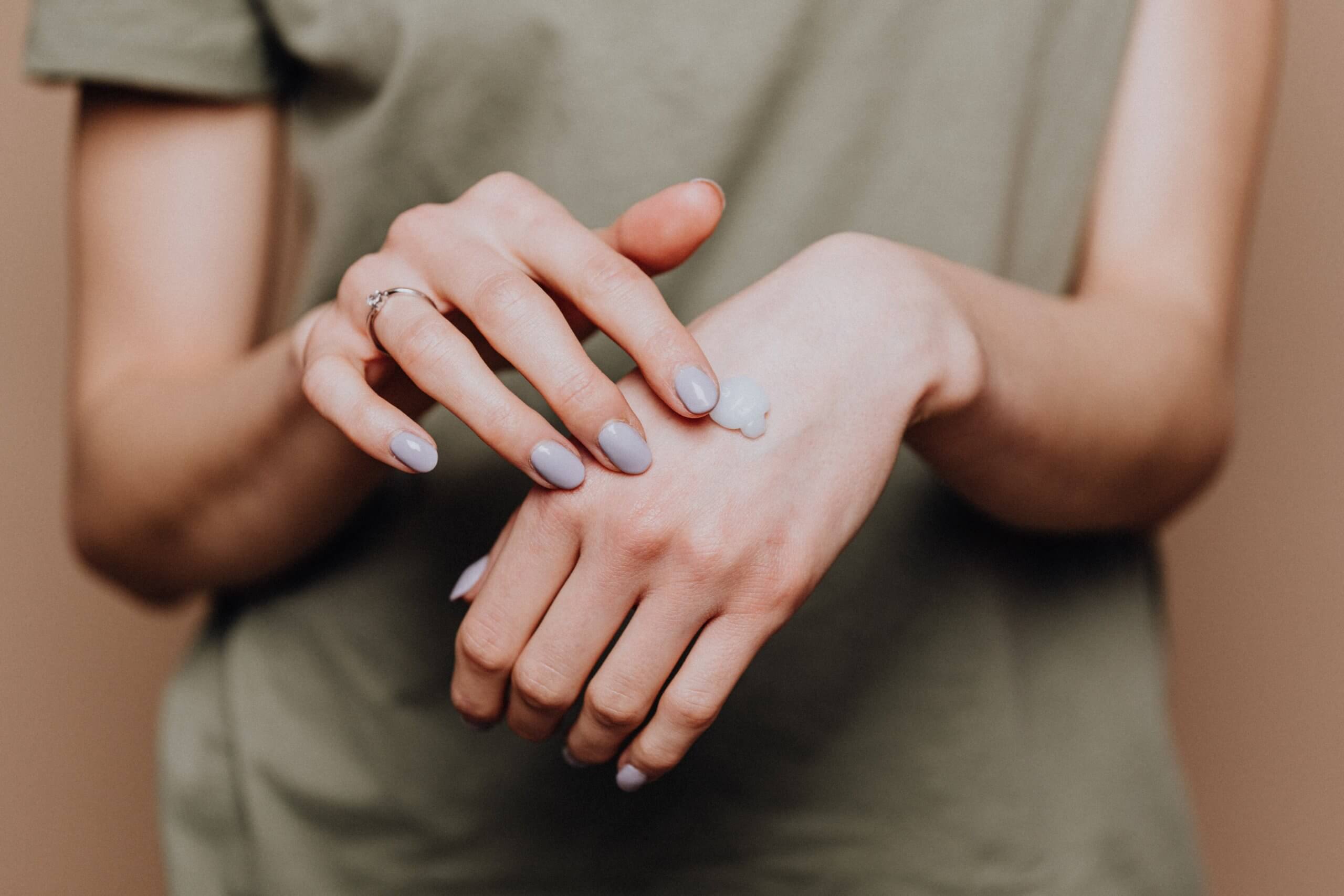 a lady applying hand cream