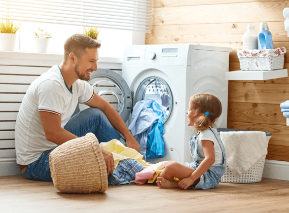 man-and-girl-next-to-washing-machine